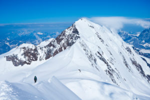 1 mountaineer on the summit ridge Ludwigshöhe, view to the Liskamm, Monte Rasa, Italy 1 mountaineer on the summit ridge Ludwigshöhe, view to the Liskamm, Monte Rasa, Italy